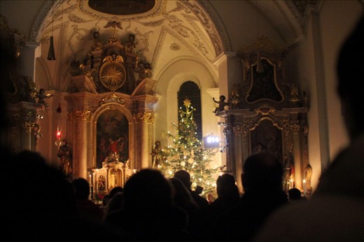 The local church slowly fills with people for the midnight mass, including Josef and his family. Everything is still, the silence broken only as the organist begins to play 