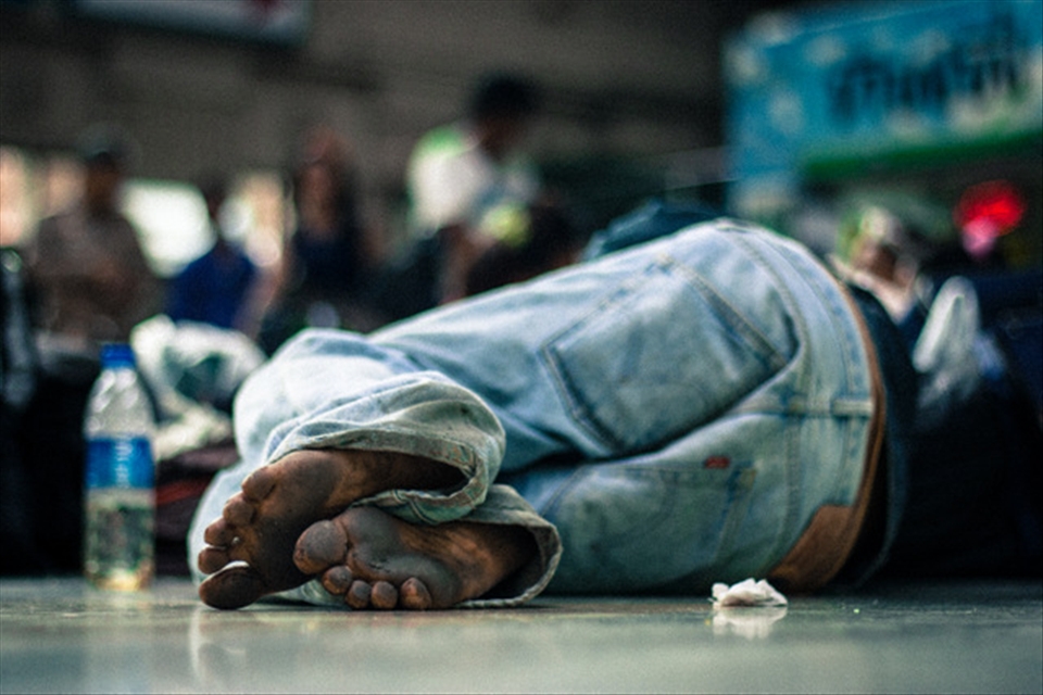 A man's sleeping on Hua Lamphong's floor