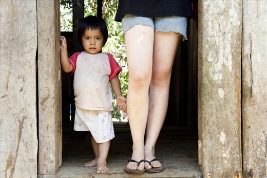 Omar, a young Shuar boy stands next to Stephanie, a German woman who was undertaking anthropological study in the community of Arutam through the cultural exchange program.