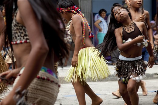 A group from an Indigenous Kichwa community performs dances in costumes that are unique to their community, demonstrating different cultural practices that exist within the Pastaza province, Ecuador.