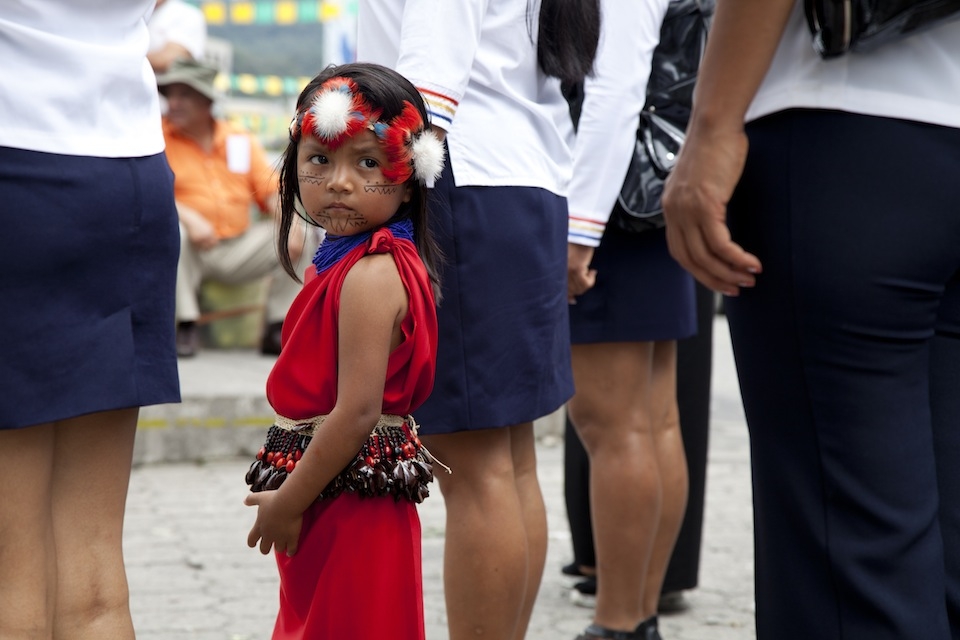 A young girl from an Achuar community participates in a parade in Puyo, Ecuador to celebrate the many Indigenous cultures and traditions that live in the Pastaza province.