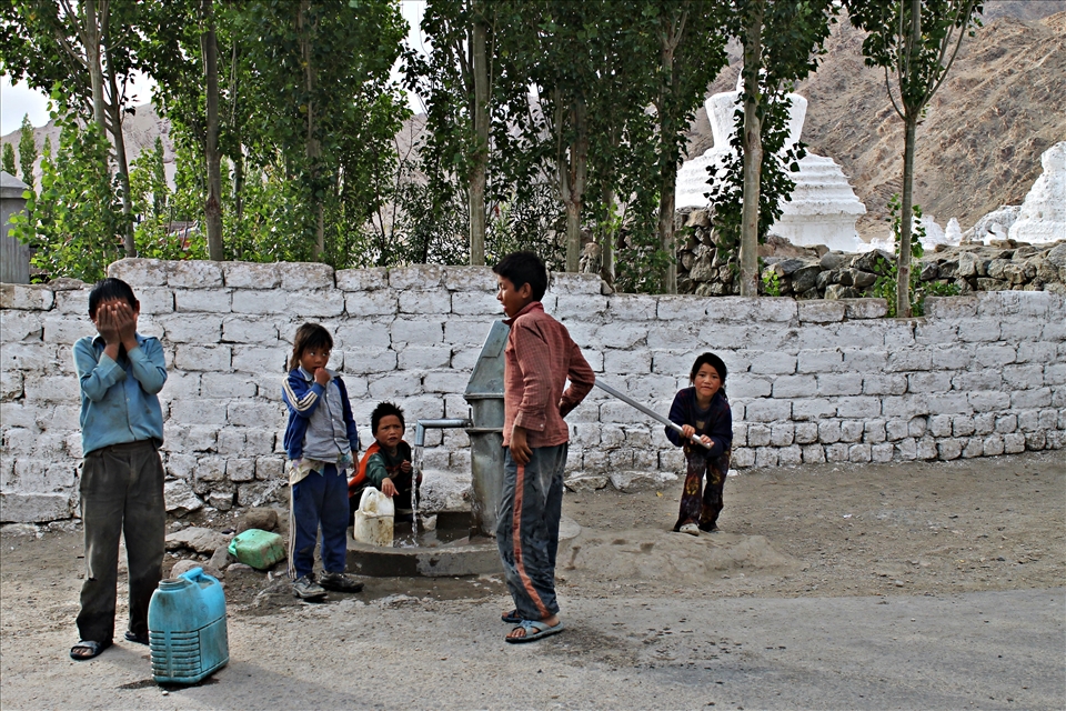 A bunch of kids having their share of fun and frolic in the evening post school.