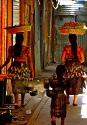 Any traveller can appreciate the sights, smells and sounds of the local market. In this particular one, I was unfortunately too slow to snap a child playing inside a bucket of rice with his toy before his mother grabbed him and sold a customer a bag of it! However I loved this shot of the 3 girls on their way out of the market with their purchases. It amazed me the strength the women had to balance the huge baskets of goods on their head without a single complaint. Their companion, matching in her huipals, was trailing after them, dragging her bucket and singing to herself as they left the bustling market.: by aoifekk, Views[267]