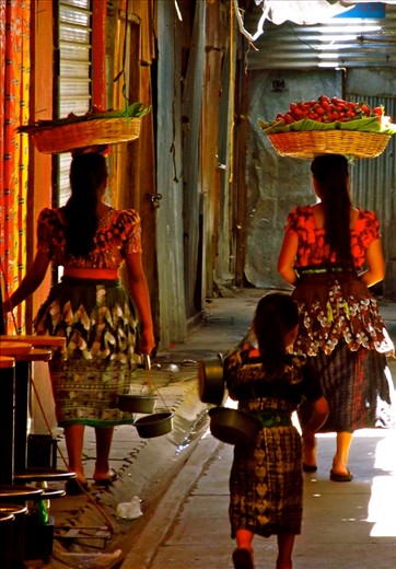 Any traveller can appreciate the sights, smells and sounds of the local market. In this particular one, I was unfortunately too slow to snap a child playing inside a bucket of rice with his toy before his mother grabbed him and sold a customer a bag of it! However I loved this shot of the 3 girls on their way out of the market with their purchases. It amazed me the strength the women had to balance the huge baskets of goods on their head without a single complaint. Their companion, matching in her huipals, was trailing after them, dragging her bucket and singing to herself as they left the bustling market.