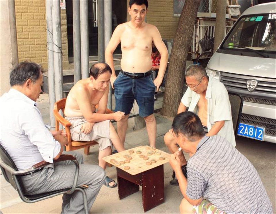 Beijingers love 象棋. 1 vs 1, on the street, but never less than 5 around a table