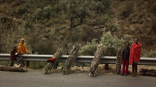 Sotho children selling wood by the rail of the A1, over the Moteng Pass.