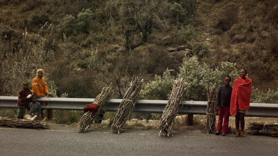 Sotho children selling wood by the rail of the A1, over the Moteng Pass.