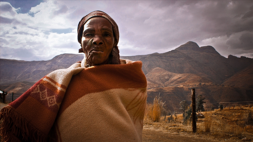 Sotho woman in the village of Phelandaba, on the background of mighty Drakensberg.