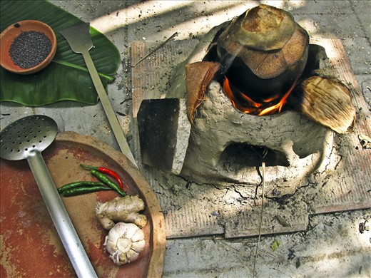 Smoking the green coconut on the blazed up clay oven in my backyard.