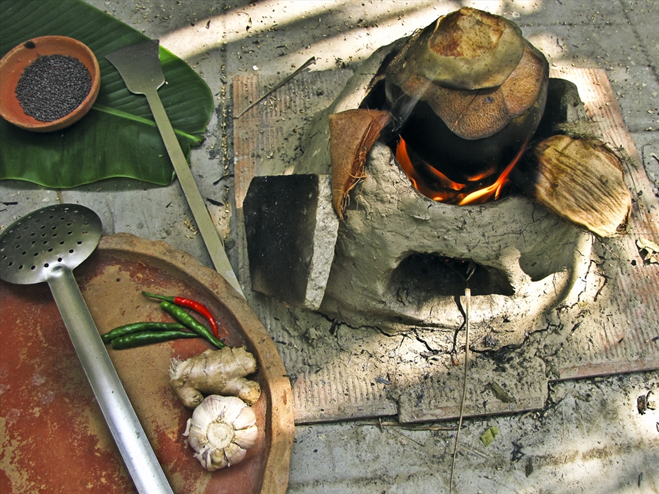 Smoking the green coconut on the blazed up clay oven in my backyard.
