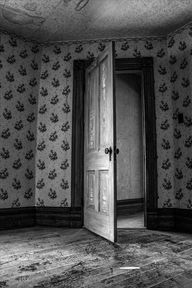 An empty room in an empty house where a family once lived.