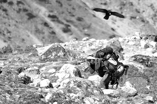Sherpa carrying backpacks to the Everest Base Camp