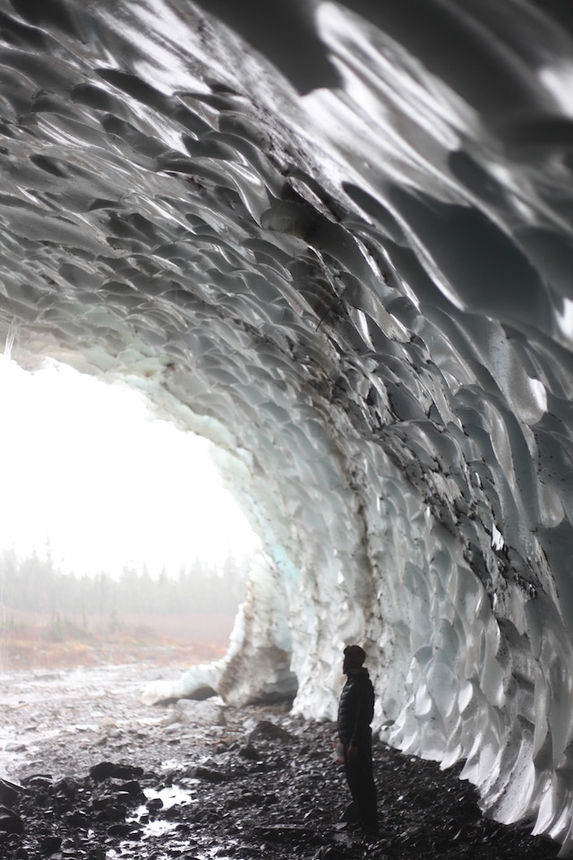  An overarching ice cave provides refuge from the unforgiving rain.