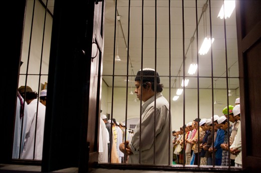 Moslem praying together during magrib after breaking from the fast. After the break, they pray Magrib together. Then come back to the table for having heavy meals, usually rice with some other dishes. 