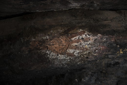 This is a traditional Aboriginal cave painting at Injalak Hill, 5kms west of Gunbalanya in Arnhem Land, NT. Painted with white and red ochre this painting is believed to be over 10,000 years old. Hand stencils are very common in Aboriginal rock painting, this particular one is considered very rare due to the detail added into what would normally be negative space.