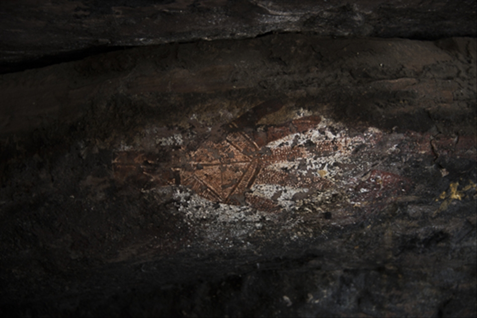 This is a traditional Aboriginal cave painting at Injalak Hill, 5kms west of Gunbalanya in Arnhem Land, NT. Painted with white and red ochre this painting is believed to be over 10,000 years old. Hand stencils are very common in Aboriginal rock painting, this particular one is considered very rare due to the detail added into what would normally be negative space.