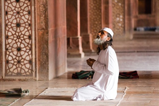 A man prays in a mosque by the shrine of a Sufi saint in Fatehpur-SIkhri. 