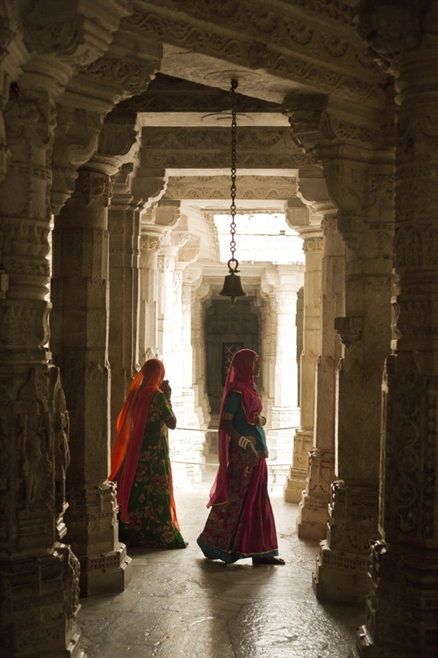 Women walk through a Jain temple built in 1439. Ranakpur, Rajasthan.