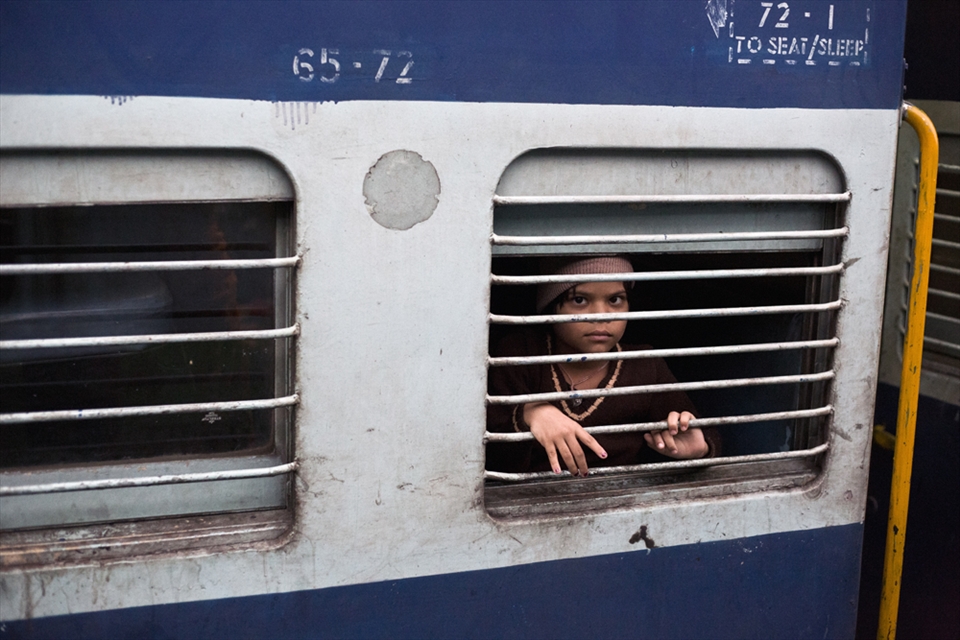 A girl waits in a train early in the morning in Udaipur, Rajasthan.