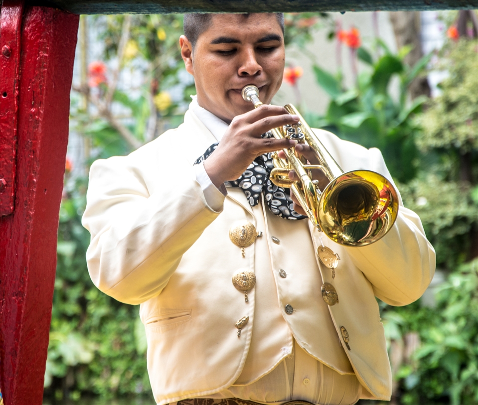 Mariachi trumpeter working on a boat.