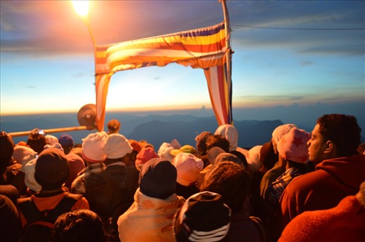 People from many countries including the locals are waiting for the most spectacular event at the top of the Adam's Peak.  It's the sunrise of a new day. People climb 2,243 metres (7,359 ft) to see this and the most of Buddhists do this as a pilgrimage as they believe the sacred foot print of Lord buddha.