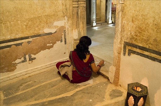The children’s mother, resplendent in a deep red sari, paints a white rangoli design in the entranceway to the haveli. This is meant to bring luck and to welcome Lakshmi, the Hindu goddess of wealth, into their home for the Diwali celebrations. When she was finished she handed me the brush and watercolor paint and let me create a design in the opposite doorway. The 150 year old walls, with their crumbling plaster and paint work, are a lovely backdrop.