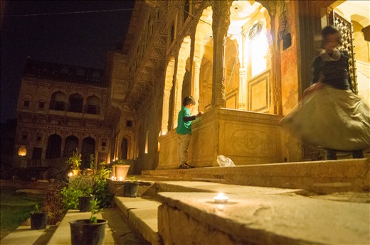 My host’s son carefully lights tea lights in the dramatic archway at the entrance to the haveli while his sister twirls to show off her party skirt.  Soon after sunset we had filled every alcove and stairway in the front courtyard of the haveli with twinkling lights.