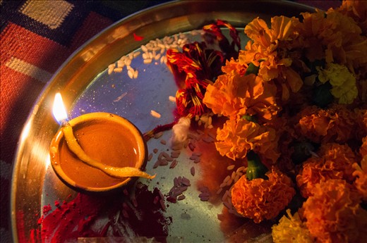 This year I spent Diwali, the Hindu Festival of Lights, with an Indian family in a restored 150-year old haveli in eastern Rajasthan. We lit candles and tea lights around the house, painted designs in the doorways to welcome Lakshmi and gathered in front of the family's shrine to offer puja or prayers and songs. After dinner, the front yard was ablaze with fireworks and sparklers. It felt like Christmas and the 4th of July all rolled into one luminous evening and it was wonderful not only to witness the celebrations but to take part in them with the family. On this silver thaali are some of the items used by the family in worship: a diya or clay lamp filled with oil and a cotton wick dipped in ghee, puffed rice and marigolds.