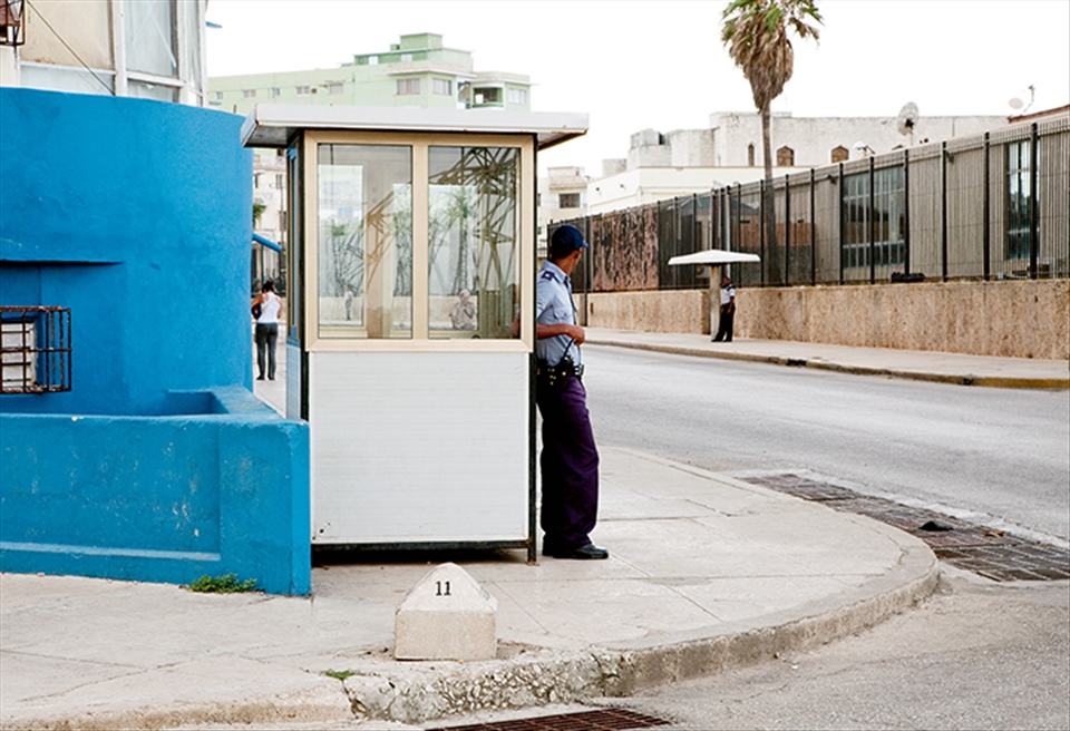 An officer stands guard, listlessly outside of the United States embassy.
