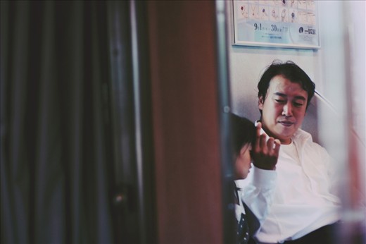 Man with his daughter. Playing with her hair. The train was nearly empty. It was so soothing and calming.