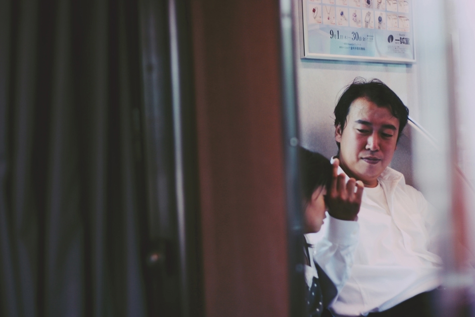 Man with his daughter. Playing with her hair. The train was nearly empty. It was so soothing and calming.