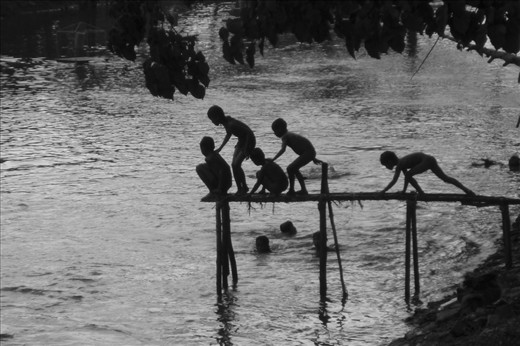 Local children play in the river, escaping the heat of the day.