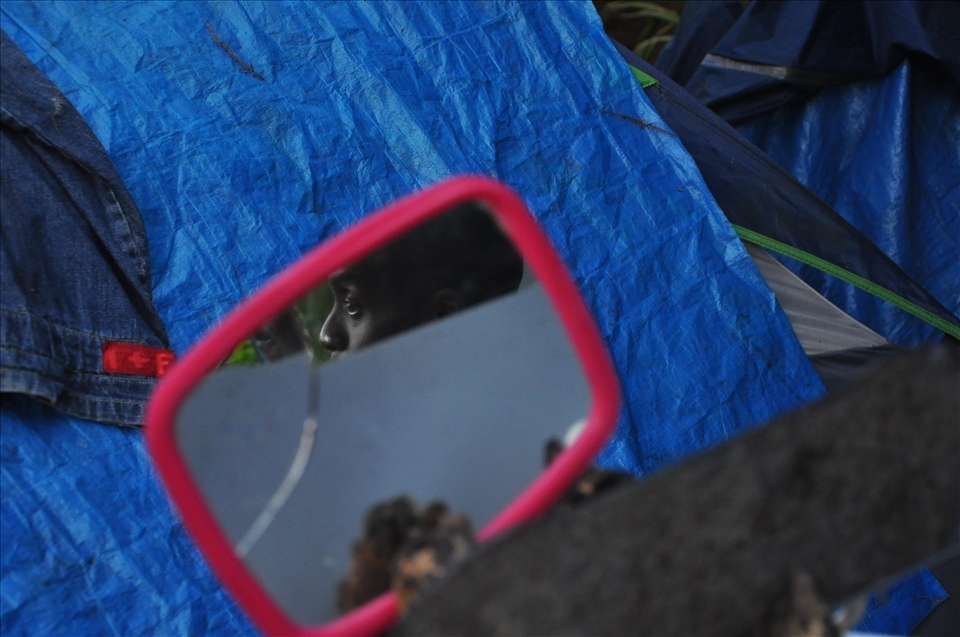 A veteran of the US Marine Corps sits reflected in a cracked mirror used for sha
