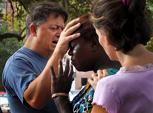 Two missionaries pray for the situation of those living in Tent City.