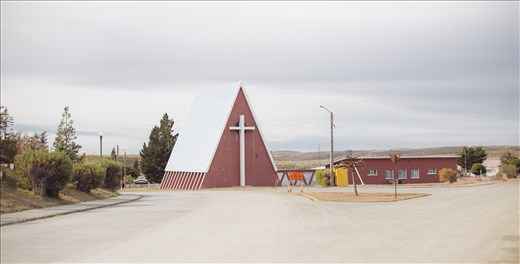 The once thriving oil town of Cerro Sombrero now almost appears post-apocalyptic to modern day visitors.  It was an artificial town designed to house the huge numbers of miners and their families that were once required to maintain the thriving fossil fuel industry in the area but in recent years its population and funding have dropped in proportion to the regions production.  This church is one of the few buildings that is still used and maintained; around it lie huge gymnasiums, theatres, swimming pools and community centres that have since fallen into various states of disrepair.  It stands as a physical reminder of Chile's new shift towards renewable energies as the cure for its soaring energy requirements and desire for energy independence.  Incidentally, the people of Chile are becoming more and more engaged in the countries energy direction and legislation.  Chile's primary source of renewable energy, hydroelectric, has come under the spotlight due to its environmental impacts and an increasing awareness of the fact that the vast majority of energy in the country is used to power its Northern copper mines rather than for the energy requirements of its citizens.