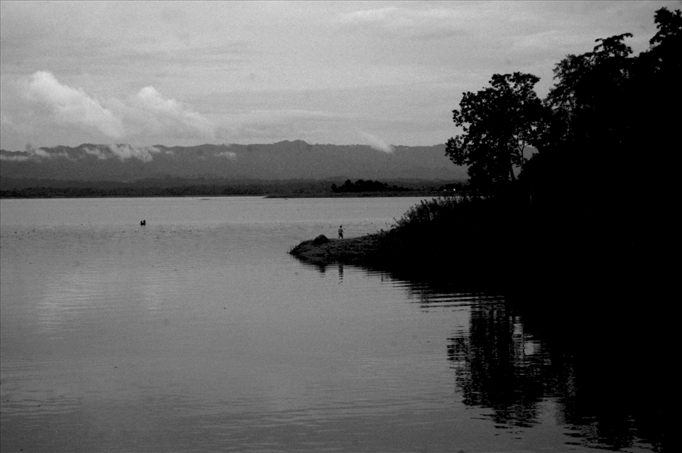 On the Other Side - A man looks at a passing boat at Rangamaati