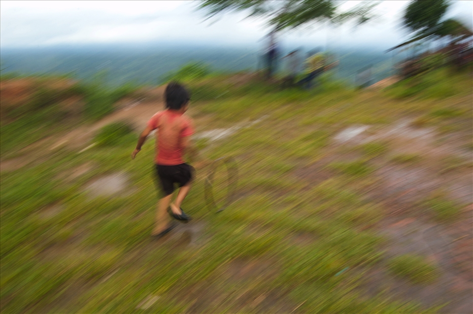 Circle of Life - A boy plays with tire near the Hills of Bandorbon