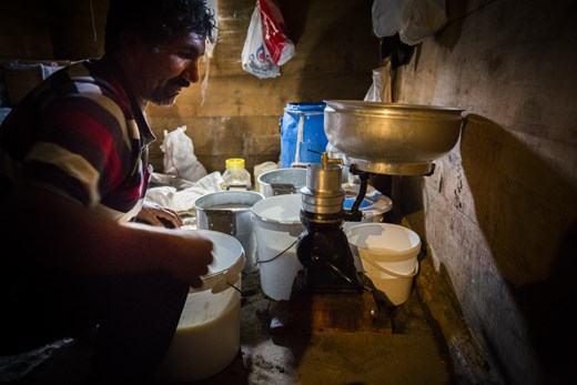 A shepherd shows how he makes chees in his house.
