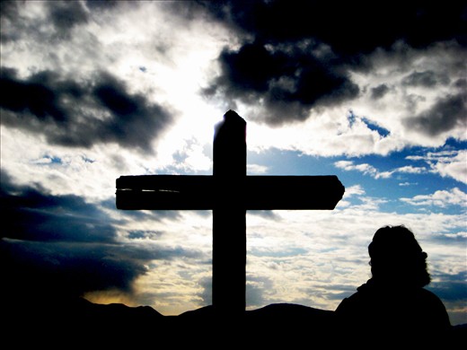 A woman says prayer atop Cross mountain in Medjugorje