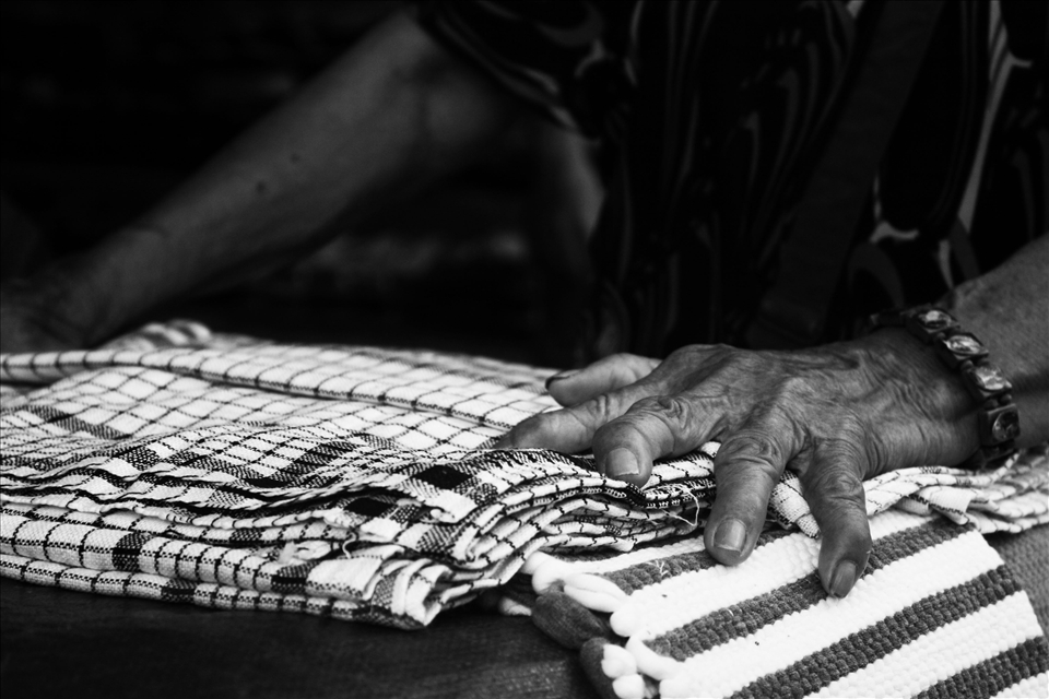 The working hands of a Bosnian woman adorned with virgin Mary bracelet . 