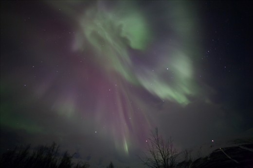 A Coronal Aurora, beautifully shaped, coming from right above us and drawing dancing curtains in the sky - such a beautiful sight. This stunning display resulted from 2 small solar explosions 3 days earlier. Photo taken in Abisko/Sweden. 