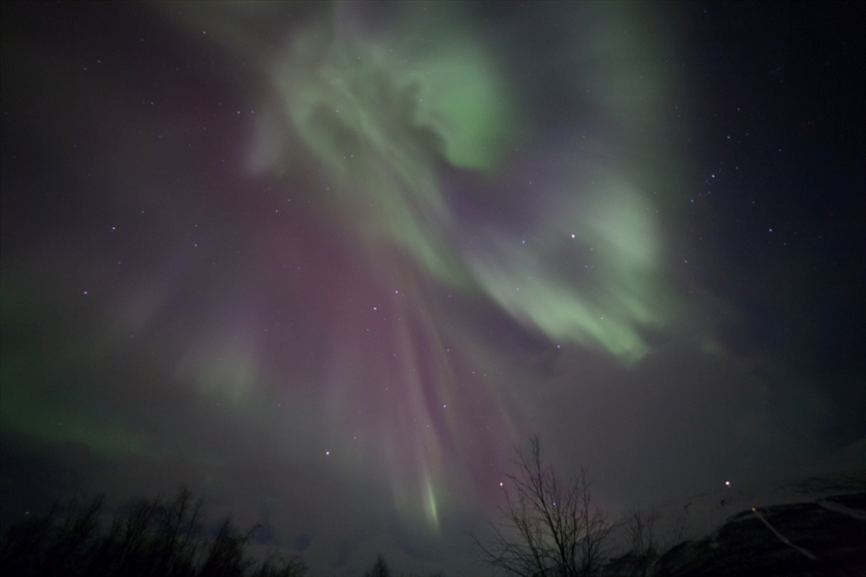 A Coronal Aurora, beautifully shaped, coming from right above us and drawing dancing curtains in the sky - such a beautiful sight. This stunning display resulted from 2 small solar explosions 3 days earlier. Photo taken in Abisko/Sweden. 