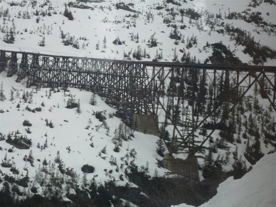 train tracks going thru snowy mouantain.