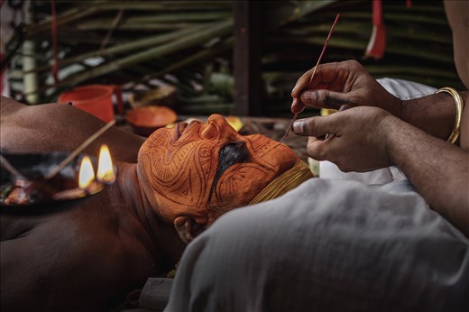 The costume as well as the facial make-up of each theyyam .
