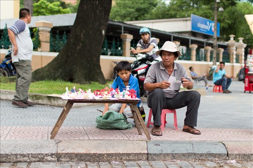 Paper Art. A boy helping his father selling paper art during summer break. You can get them for 1 dollar each, while its almost 10 bucks here in America. The stand was right in front of the City Post Office, where tourists come by a lot. 
