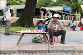 Paper Art. A boy helping his father selling paper art during summer break. You can get them for 1 dollar each, while its almost 10 bucks here in America. The stand was right in front of the City Post Office, where tourists come by a lot. : by baohan, Views[296]