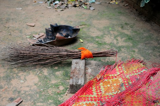 Simple tools for a simple life. A handmade broom of twigs is held together with an orange strip of fabric torn from a monk's robe. Siem Reap - Cambodia
