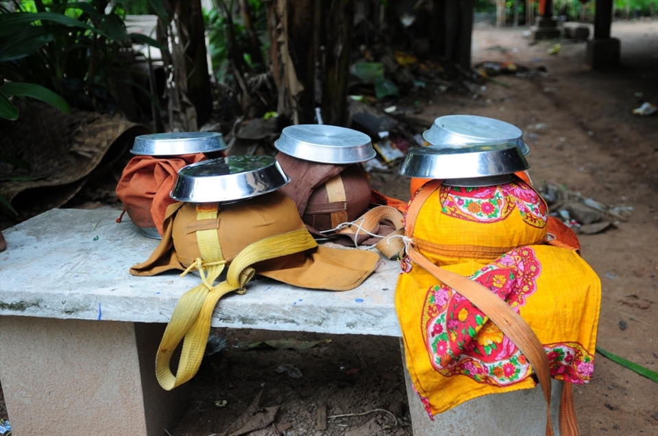 Monks are dependent on on the generosity of others for their most basic needs. Alms bowls sit cleaned and ready for the morning walk. 
Each morning Monks walk the streets to receive gifts food and water from the public. In exchange the monks will recite a prayer fo the donor. Siem Reap - Cambodia