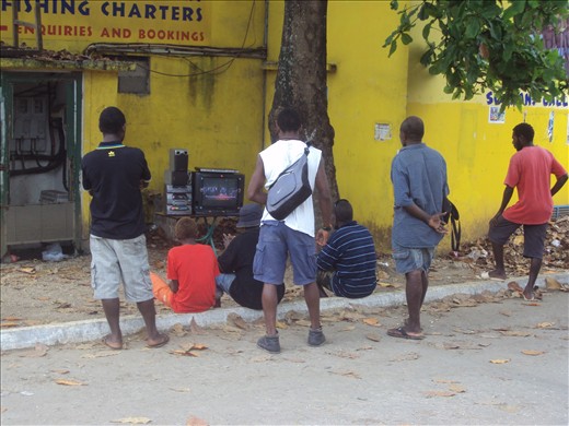 Ni-Vanuatu watching TV after work on the main street in Port Villa 