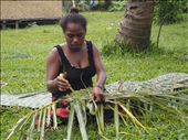 Vanuatu woman making coconut leaf basket used to carry goods: by bart_australia, Views[655]
